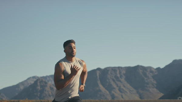 Confident young man running